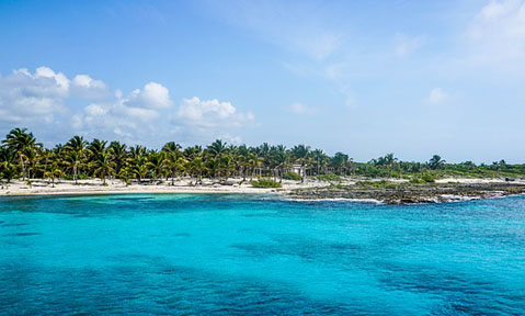 A tropical view of turquoise sea and white sand beaches from a Mexico yacht charter